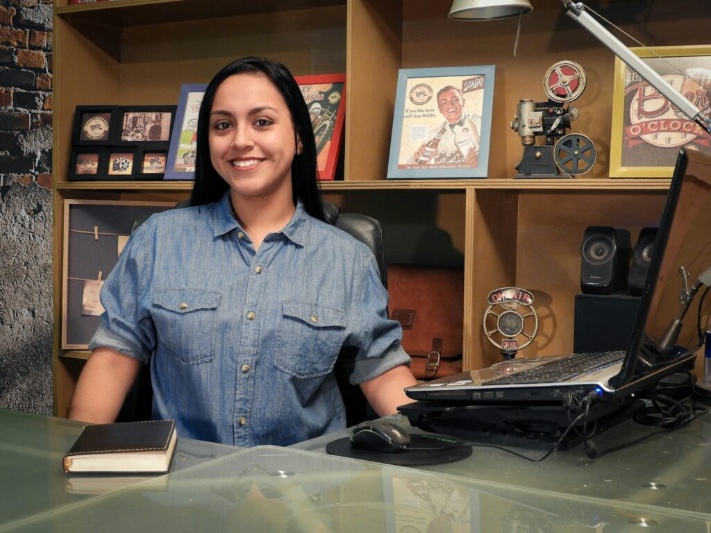 woman in blue button up shirt smiling
